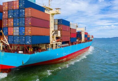 Container ship loading and unloading in deep sea port, Aerial top view of business logistic import and export freight transportation by container ship in open sea.